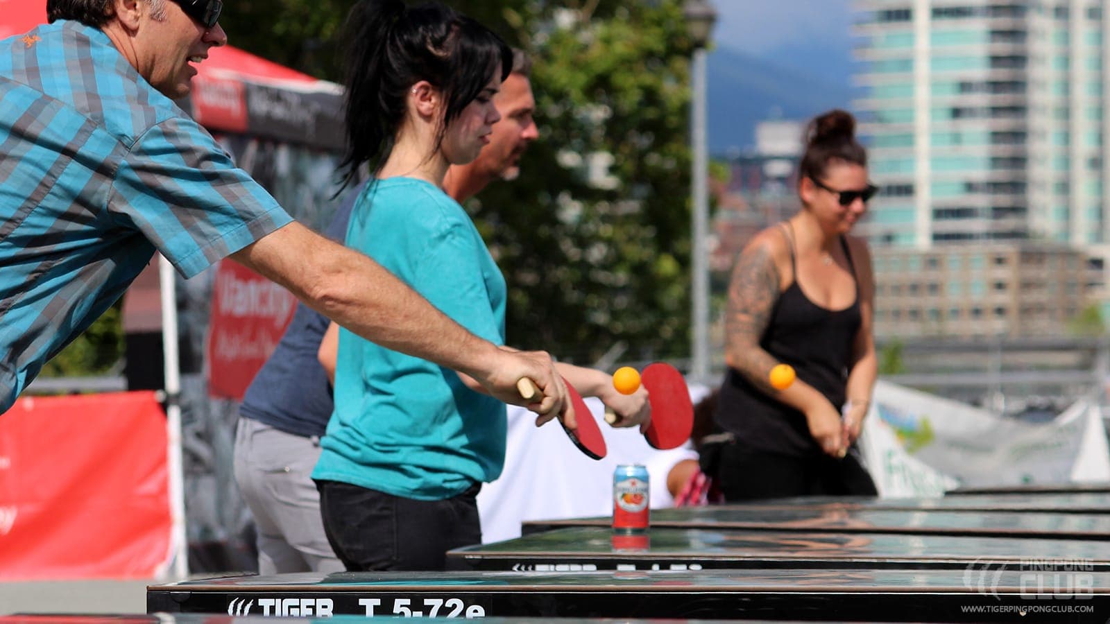 People rallying on Tiger tables outdoors at Vancouver's Food Cart Fest.
